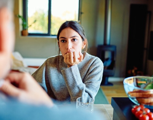 A woman looking at another person thoughtfully