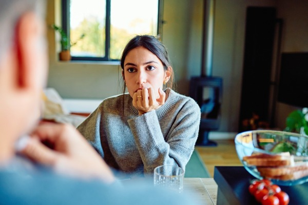 A woman looking at another person thoughtfully
