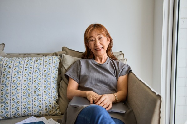 Woman sitting on a couch smiling