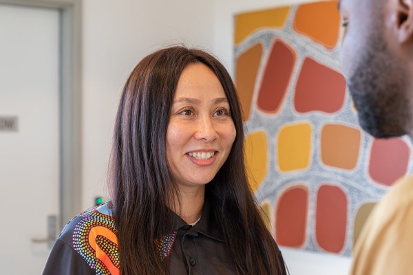 A woman talking to another person and smiling