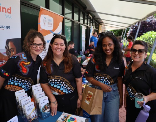 Four Richmind WA staff at a stall promoting our services and smiling